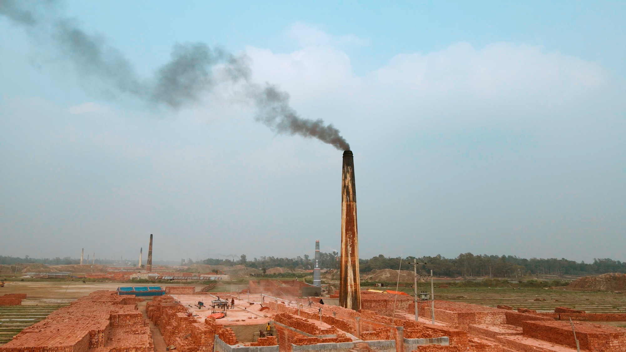 Aerial view of brick kilns along a river in Bangladesh